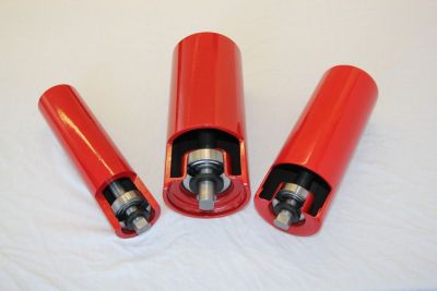 Cross-section comparison of red conveyor idlers showcasing standard design, heavy-duty housing (SLT), and machined counter-bored bearing seat (HLR)