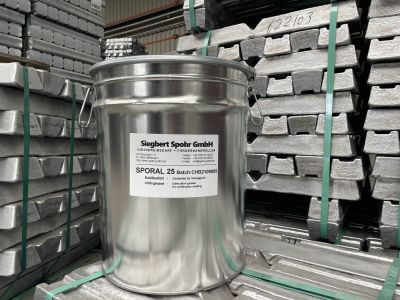 SPORAL mold release compound pail displayed in a foundry production hall with stacked aluminum ingots in the background