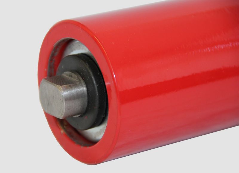 Close-up view of a red conveyor roller type hlr showing the flat shaft end