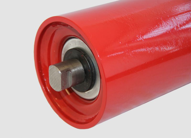 Close-up view of a red conveyor roller type slt showing the flat shaft end