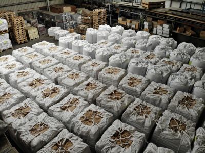 Overhead view of a massive warehouse filled with row after row of big bags containing slag coagulant for large-scale foundries
