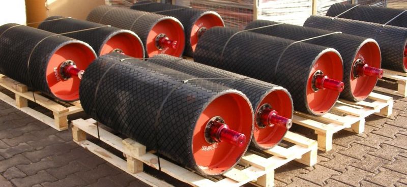 Examples of rubber-coated tailored conveyor drums packed for safe industrial delivery
